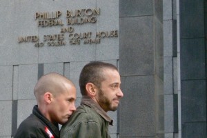 Frank and Joe Capley-Alfano listen to speeches during Monday's rally outside Federal Court