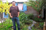 Javier Amaro stands in his garden that is watered with run-off water from his washing machine.
