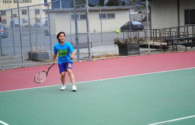 Oakland Tech tennis player Kristen Koyama returns a ball during practice on Tuesday.