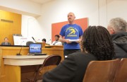 Rob Rooke, a Maxwell Park Elementary Parent and member of CPACC, shares his opposition to the upcoming school closures with the audience at Wednesday's OUSD board meeting. Photo by Roberto Daza