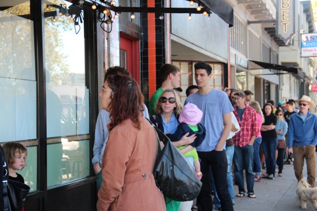 Customers gather Saturday morning on Telegraph Avenue and wait for Bakesale Betty to open for business.