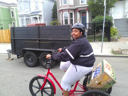 Alshea Mitchell, 20, hauls organic produce to Sav-Mor Liquors store, as part of a community program that delivers nutritious food to West Oakland's liquor stores.