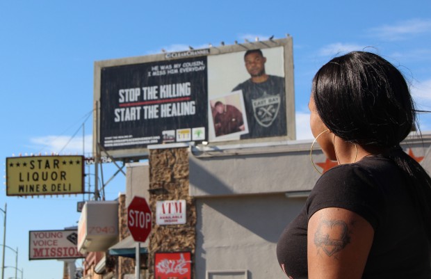 On 80th Avenue and International Boulevard, Shykelah Birchett looks at a billboard that is part of an anti-violence public awareness campaign she helped develop.