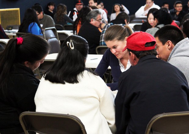USF law graduate, Marie Vincent, consults a group at a recent DACA Fair in the Fruitvale