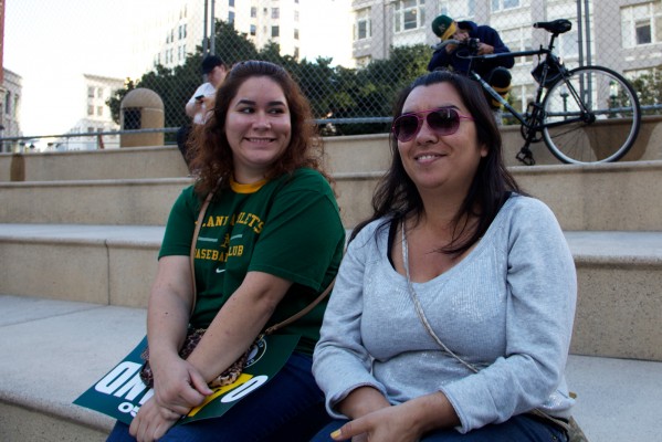 Loyal fans Erica Soto (left) and Claudio Moreno wait for the rally to begin.