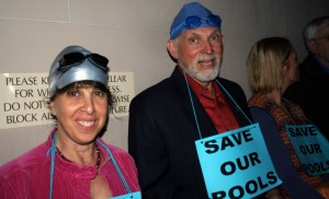 swimmers people with swim caps and goggles at city council meeting