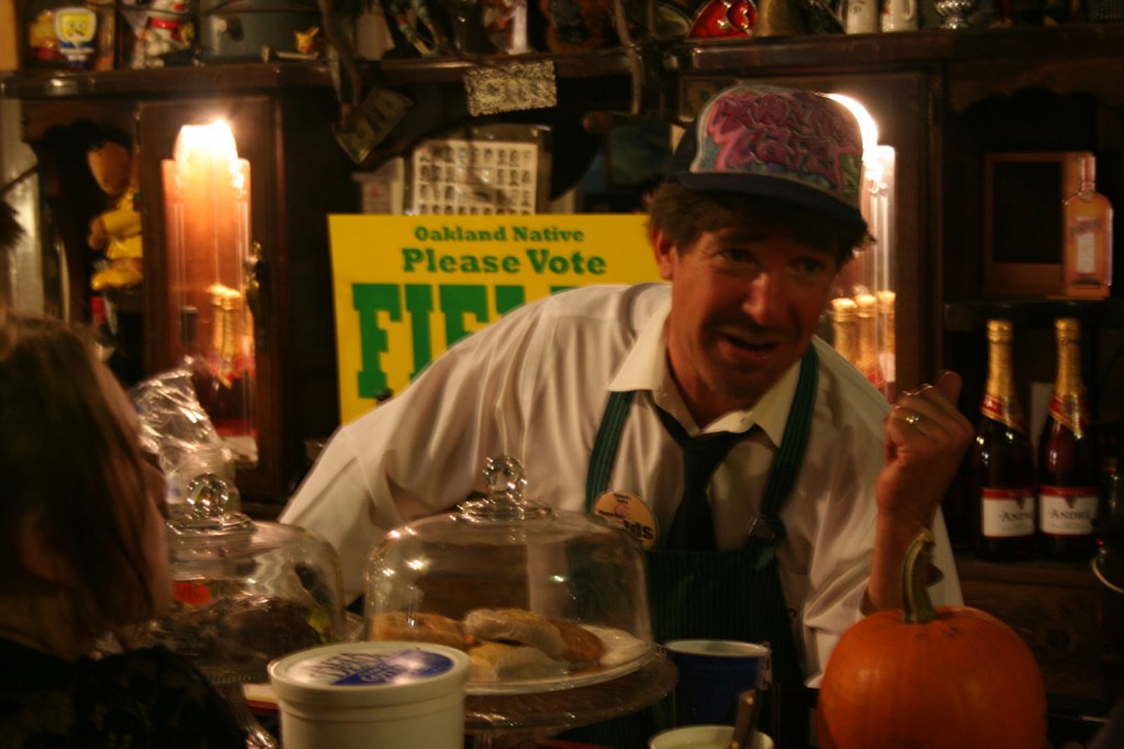 Arnie Fields talking politics behind the bar at Revolution Cafe.