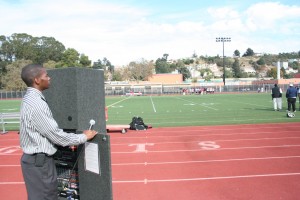 Larry Lionel Young Jr. Young looks out onto Castlemont's football field during their homecoming game against the Skyline Titans. Young has volunteered as an announcer for the East Oakland high school's football games for three years.