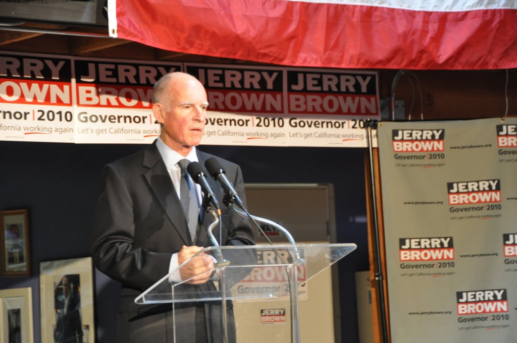 Jerry Brown talks to the press from the 3rd Street warehouse office of his campaign spokesman. The office is around the corner from the headquarters of We The People, a commune founded by Brown in 1995.