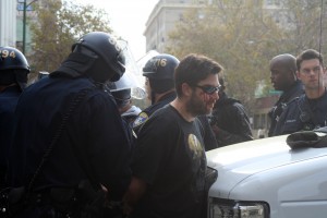 20111025_schell_occupy Police restrain a man on Franklin and 14th Street; his face is bleeding from hitting the ground when police restrained him. Photo by Brittany Schell.