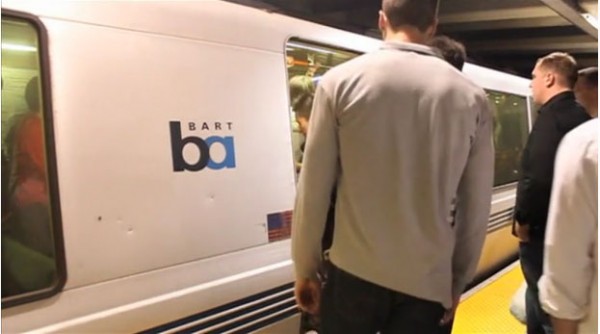 Passengers queue up on the platform.