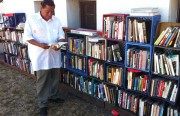 Alex Lujano browses a book at the "People's Library" in the Fruitvale district.