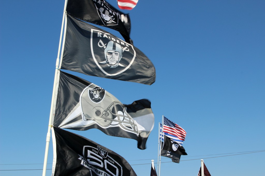 Flags fly in the parking lot of the O.co Coliseum before the Raiders third preseason game last Saturday.