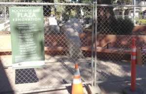 A fence surrounds the plaza renovations at Rockridge BART station.