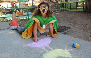 Shoshana Fendes, 9, draws a duck on the ground at Fairyland.