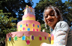 Heaven Partee, 5, poses next to the 100th birthday cake.