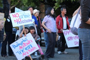 Supporters hold signs for Dear John march
