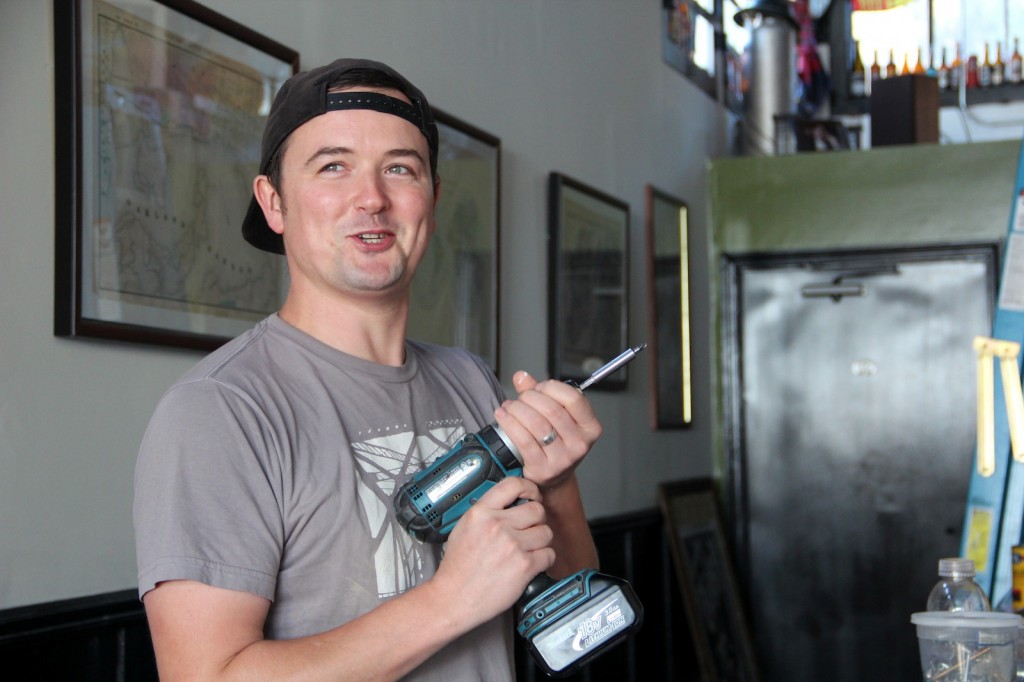 CommonWealth Café and Pub owner Ross Adair works on repairs to his business, which has been closed since a July 8 fire.