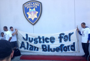 Supporters carry a banner for Alan Blueford at Saturday's rally.