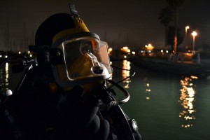Day, in a full-face scuba mask (called an AGA mask), prepares before a dive to search for bullet casings and loose teeth on the bottom of Alameda Estuary during a training exercise in September.