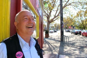 Len Raphael stands at the doorway of his campaign headquarters in the old Kasper's Hot Dog Building in Temescal.