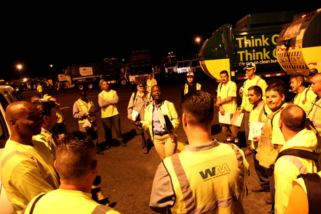 Ammie Brandon, Waste Management of Alameda County's only female route manager, talks to her crew in "the yard" about the day ahead before they ship out.