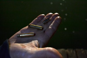 Steven Day retrieves three bullet casings from the bottom of the Alameda Estuary during a nighttime training exercise in September.