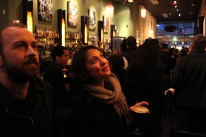 Nikola Netuschil (left) and Roma Munday (right) gaze upward at the naked artworks mounted on SomaR Bar's wall. "These pictures have very strong women in them," Netuschil said. "Most of the pictures look like real women."