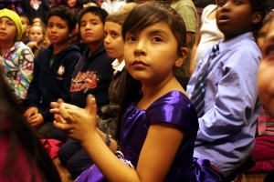 Rubi Ruvalcaba, a third grader at East Oakland’s New Highland Academy, crosses her fingers during the awards presentation in the hopes that her group project will win. It did.