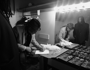 KPFA Radio host Greg Bridges jots down Kevin Weston's introductory info backstage as Weston preps to receive an award.