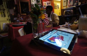 Shawn and Nedra Ginwright sit Everett and Jones BBQ in Oakland, with their family and their I-pad, awaiting the election results.