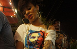 Shayla Jamerson shows off her jewelry and Barack Obama shirt outside Everett and Jones BBQ in Oakland. Photo by Pendarvis Harshaw.