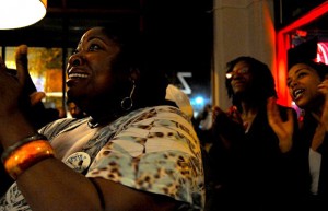Eileen Pippins, watches the television screen at Z Cafe and Bar in Oakland as President Obama was declared the winner. Photo by Angela Hart.