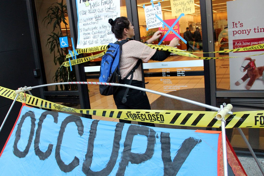 The scene outside the downtown Oakland branch of Wells Fargo. Home foreclosure protestors post the names and phone numbers of bank executives on the doors of Wells Fargo.