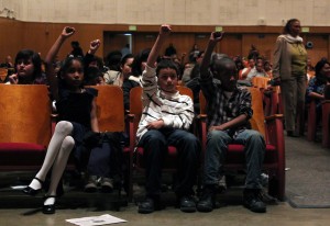 Children in the audience at McClymond's respond to a rap performance by Tyrese Johnson.