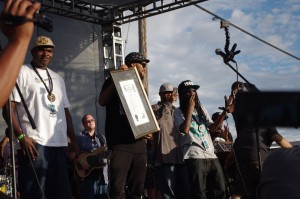 Hieroglyphics artists (from left) Casual, Tajai and A-Plus on stage hold Mayor Jean Quan's proclamation commemorating "Hiero Day" as an Oakland holiday. Photo by James Reddick.