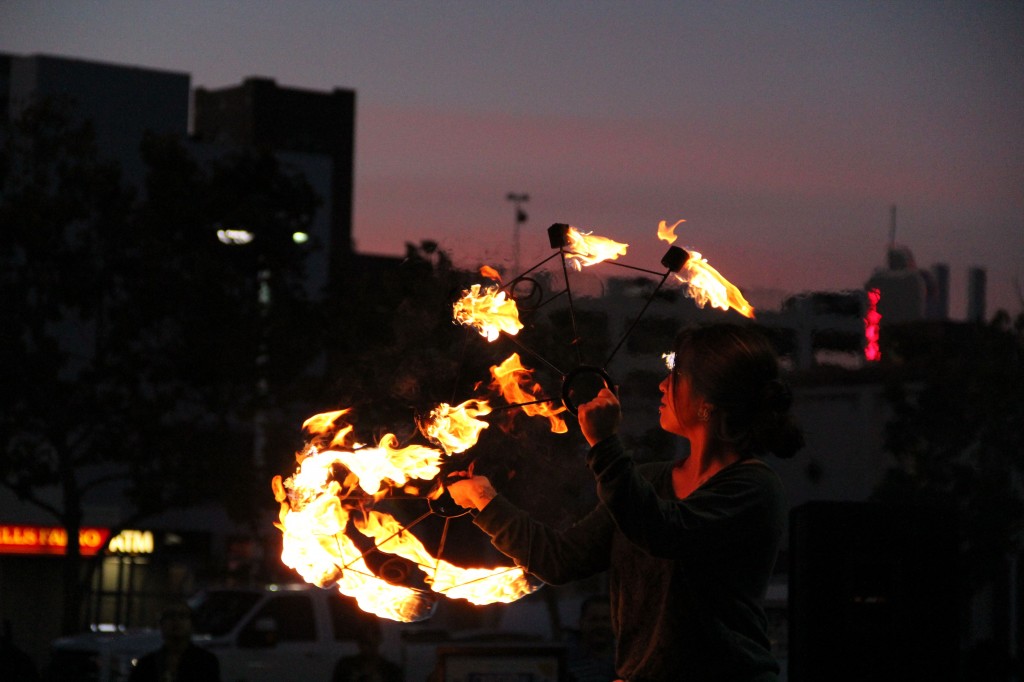 The artist known as Mel Moondala entrances the audience with her fire fans at the Vulcan Crew's first performance at Jack London Square.