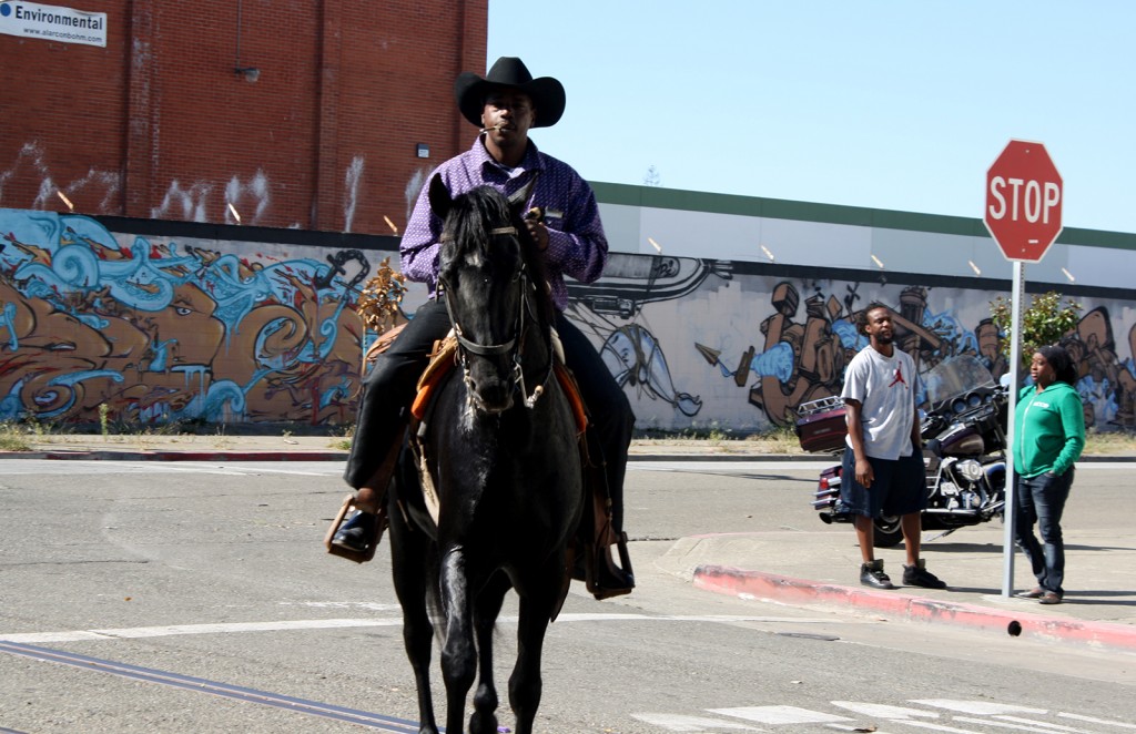 A photo of a cowboy on horseback at the parade.