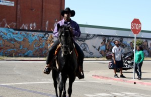 A photo of a cowboy on horseback at the parade.