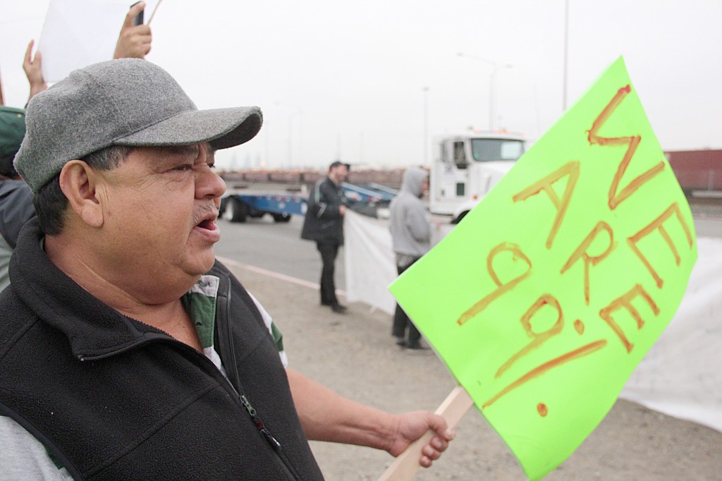 A photo of a protester holding a sign.