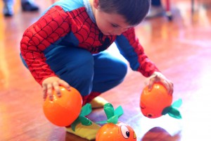 A boy collects blow-up pumpkins