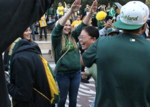 A's fans doing A's players' home run celebration.