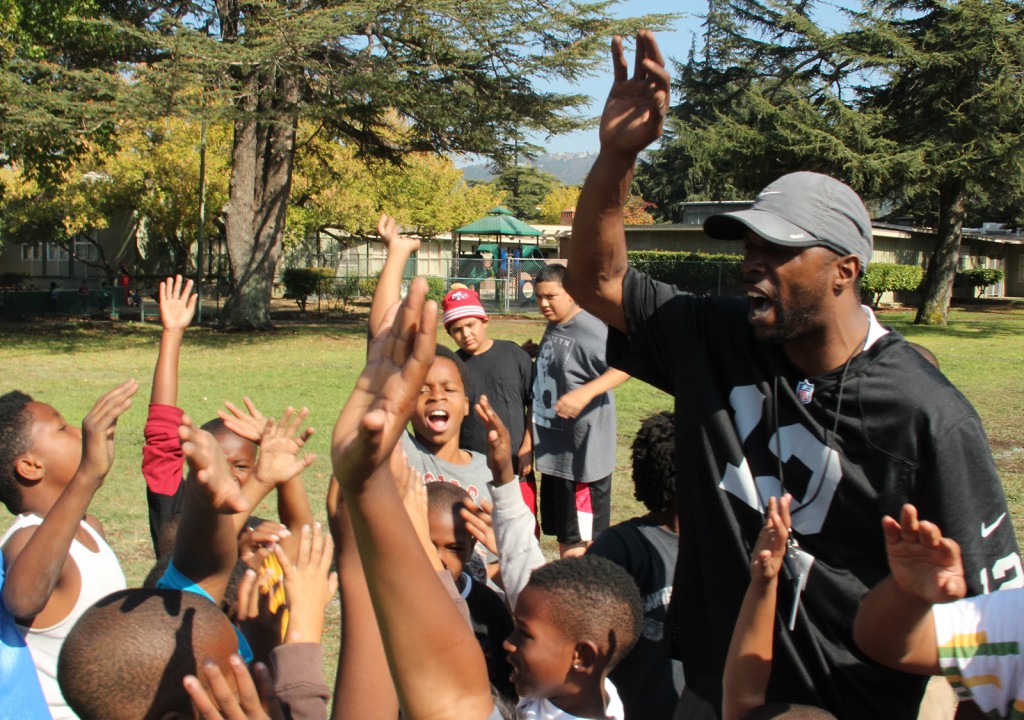 Kids and Coach Smith get together to end practice.