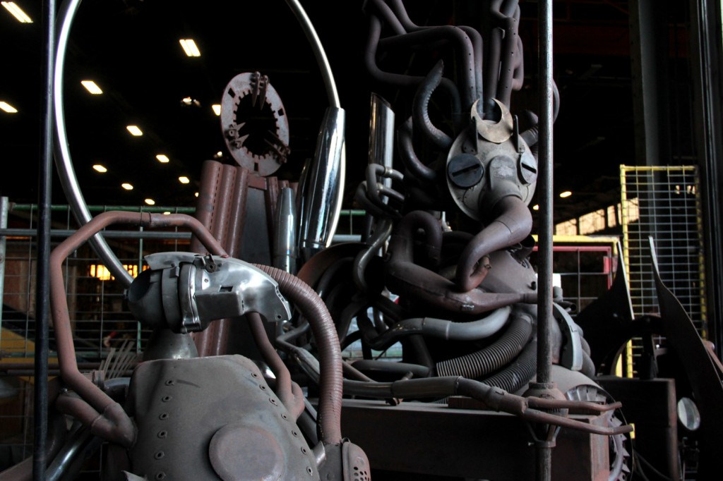 A "gargoyle" made by artist Ryon Gesink from recycled motorcycle and car parts at the entrance to American Steel Studios. Photo by James Reddick.