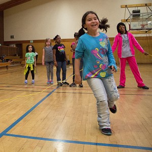 Girl smiling while playing Double-Dutch.