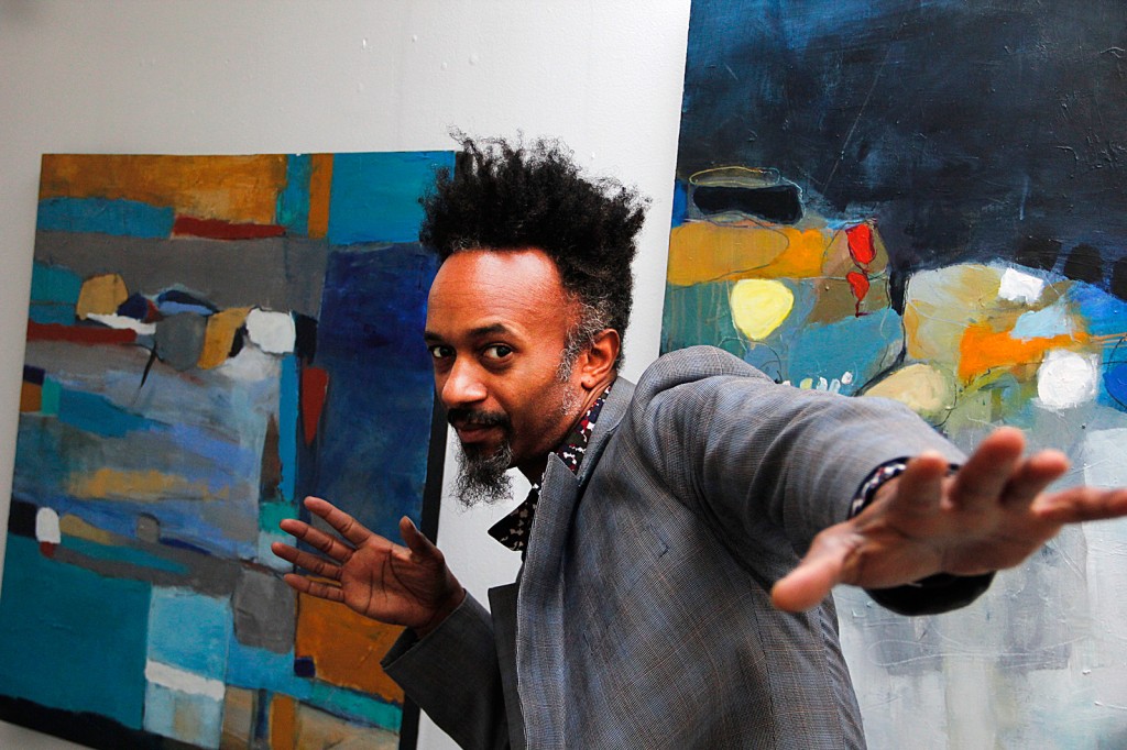 man posing in front of painting