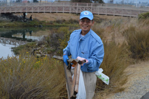 Victor Domingo carries trash picked up from the shorelines.