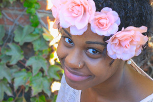 Adorned in a flower headpiece, Kiera Malone, 19, from San Francisco, takes a break in the shade. Photo by Jacqueline Ipp
