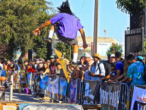 A skateboarder flies high off a trick in the mini skate park. Photo by Jacqueline Ipp