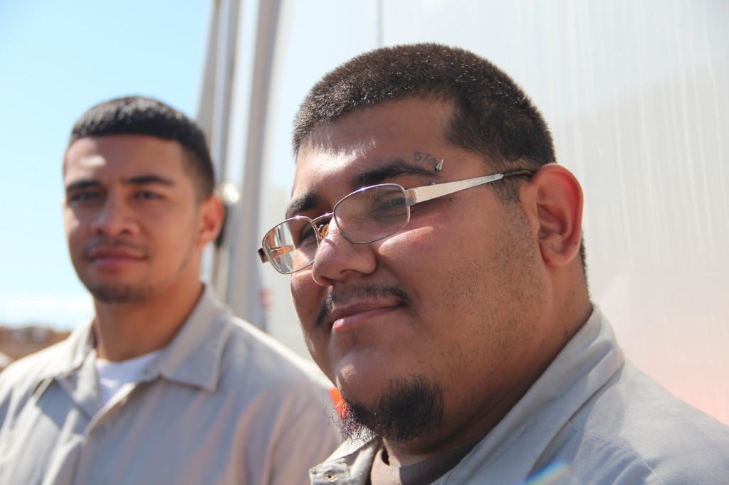 Photo shows faces of both drivers standing in front of their truck